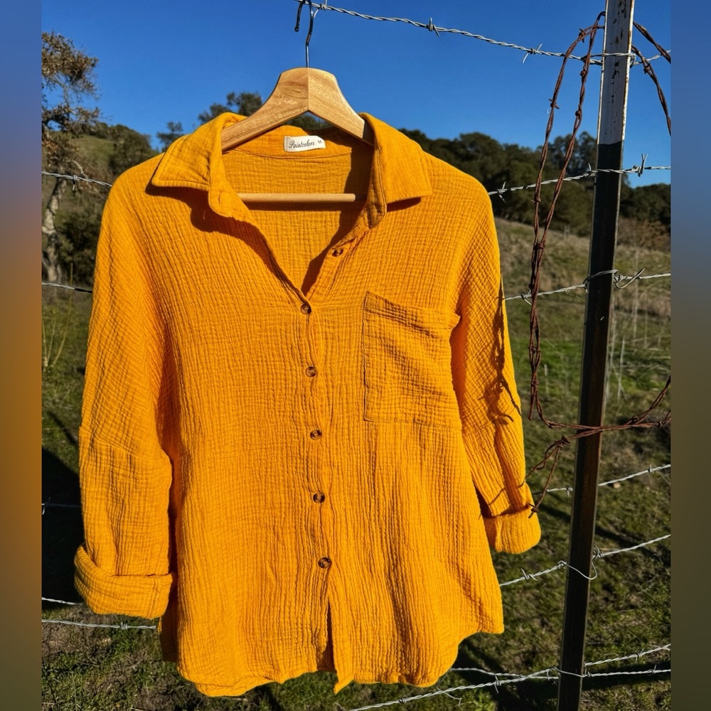 100% cotton, long sleeve, yellow button up blouse. Size medium